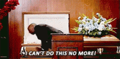 a man is laying in a coffin with the words i can 't do this no more