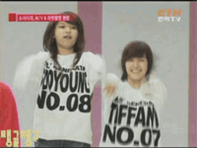 a couple of girls wearing shirts that say tiffan no.07
