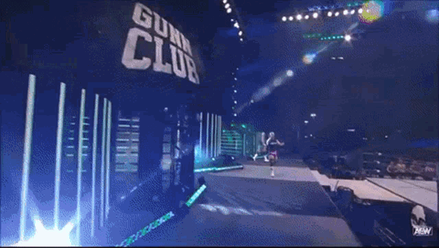 a wrestling match is taking place in front of a gun club sign