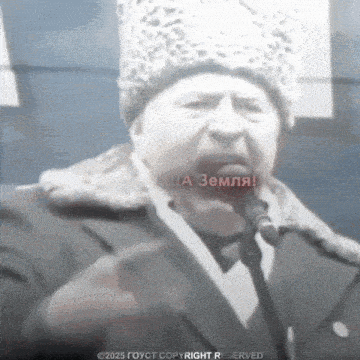 a man in a fur hat is speaking into a microphone with russian writing on his face