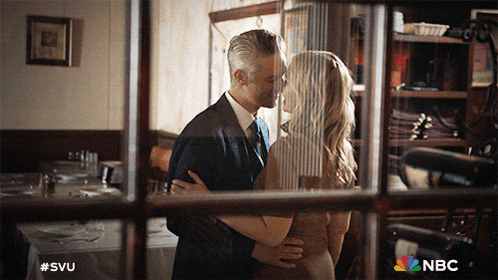 a picture of a man and woman kissing with the nbc logo visible