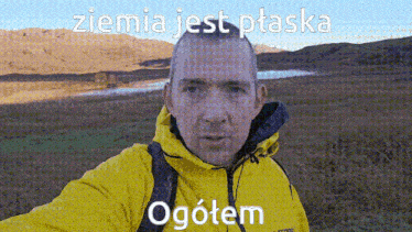 a man in a yellow jacket is taking a selfie with the words " ziemia jest ptaska ogotem " below him