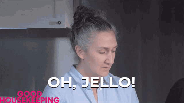 a woman with gray hair says " oh jello " in a kitchen
