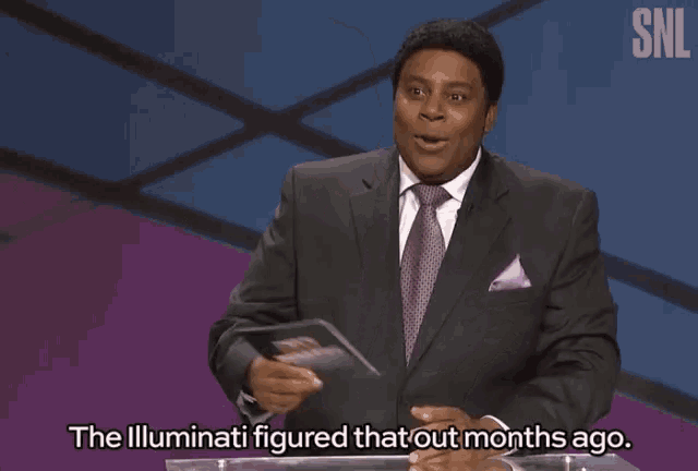 a man in a suit and tie stands at a podium with the words " the illuminati figured that out months ago "