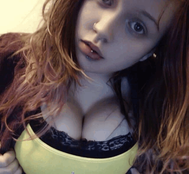 a woman with a yellow tank top and black lace top