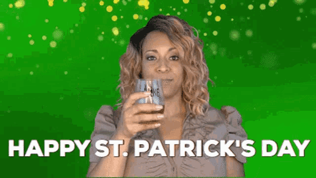 a woman is blowing a kiss while holding a glass of whiskey .