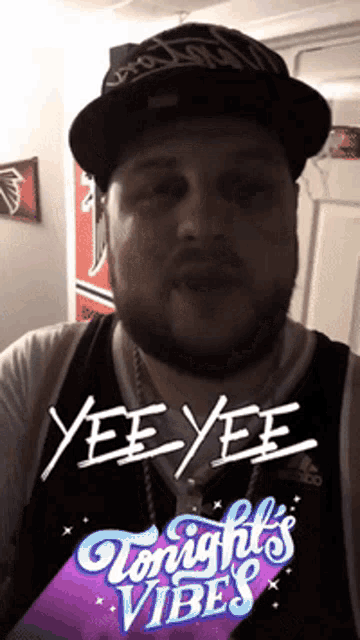 a man with a beard wearing a hat and a shirt that says yee yee on it