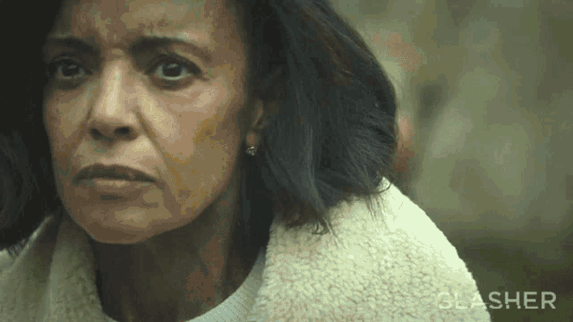 a close up of a woman 's face with the word slasher in the corner