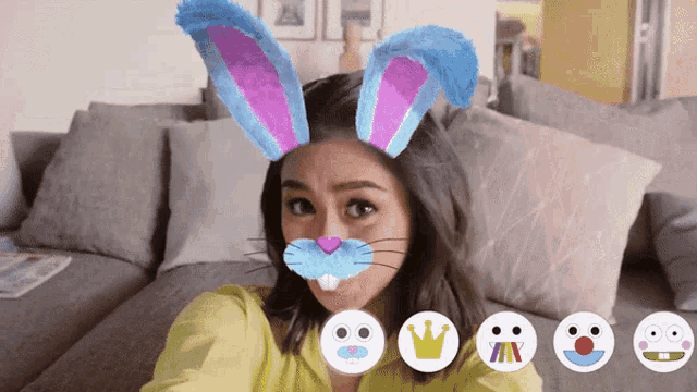 a woman is wearing bunny ears and a rabbit nose