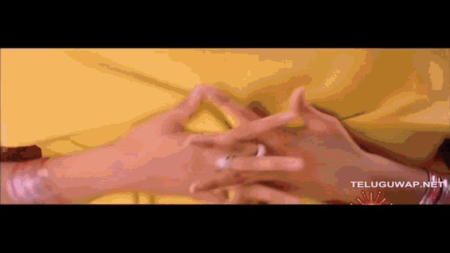 a close up of a person 's hands with a teluguwap.net watermark