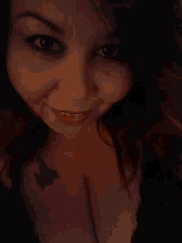 a woman with a tattoo on her chest makes a funny face
