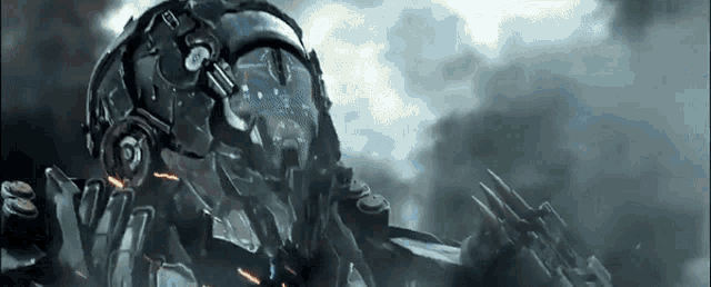a robot with a helmet on is holding a gun in a dark room .