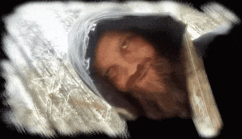 a man with a beard is wearing a hood