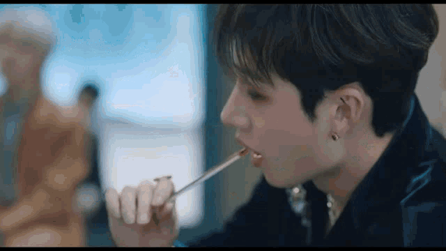 a close up of a person eating food with a chopstick .