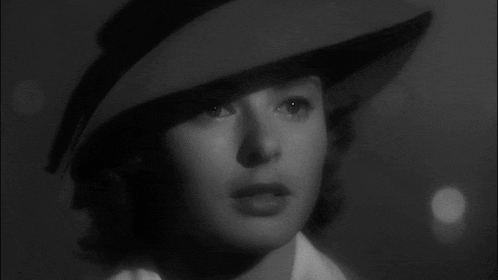 a black and white photo of a woman in a hat with the words god bless you below her