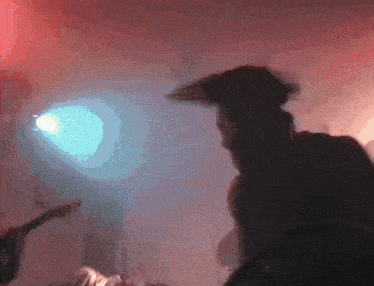 a man in a pirate hat is standing in front of a light