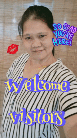 a woman in a striped shirt is standing in front of a sign that says welcome visitors