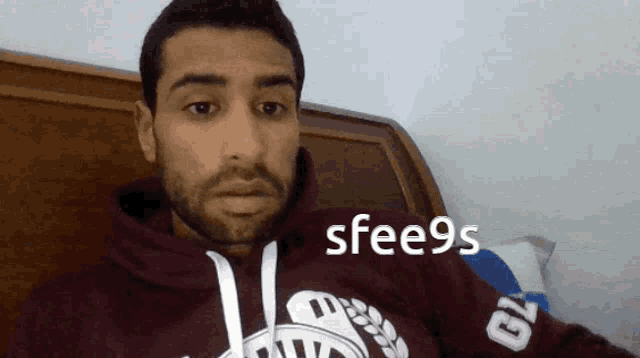a man wearing a maroon sweatshirt with the number 79 on the arm