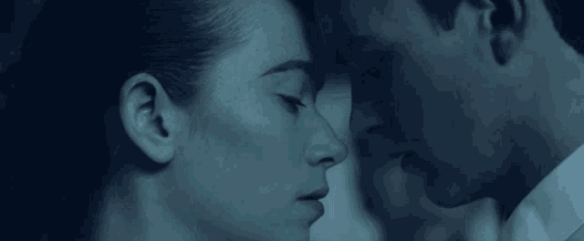 a man and a woman are looking at each other