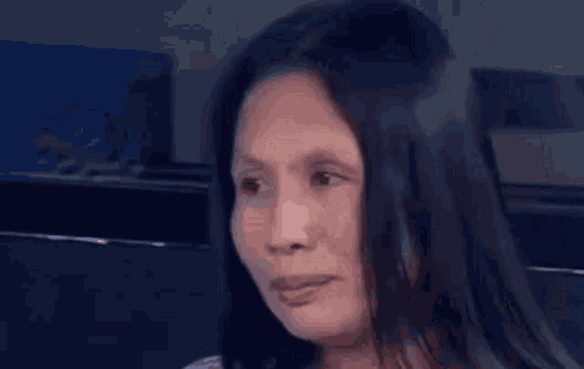 a close up of a woman 's face with a blurred background