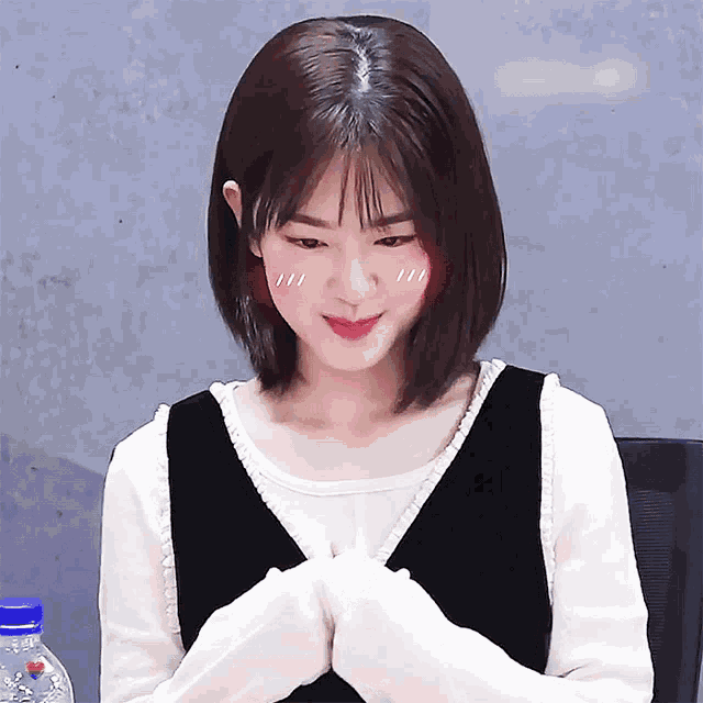 a girl with a blush on her cheeks looks at the camera