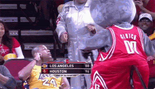 a basketball game between los angeles and houston with a mascot in the stands