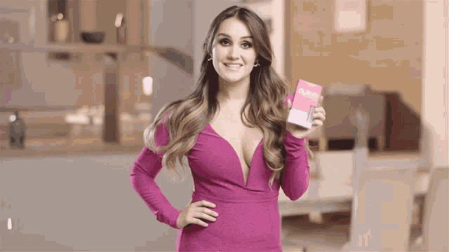 a woman in a pink dress is holding a pink box that says ' slender ' on it
