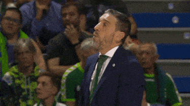 a man with a beard wearing a suit and tie