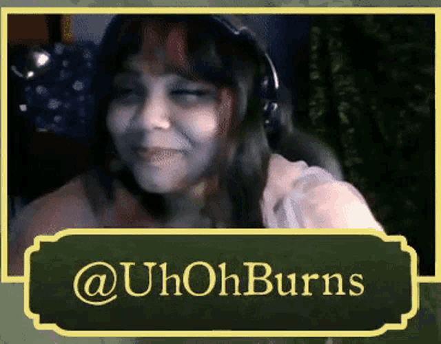 a picture of a woman with headphones and a sign that says @uh ohburns