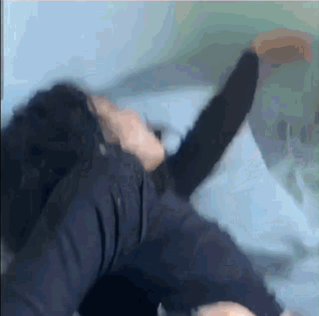 a blurry picture of a person laying on a bed with their arms outstretched