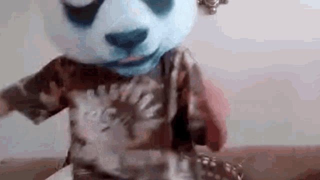 a person is wearing a panda mask and a t-shirt .