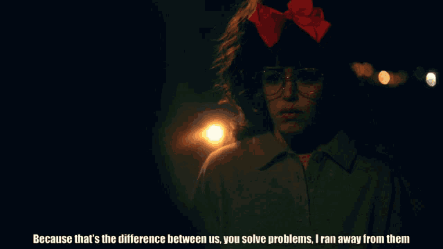 a woman with glasses and a red bow on her head says because that 's the difference between us