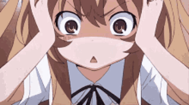 a close up of a girl with big eyes covering her ears with her hands