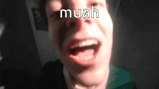 a close up of a man 's face with the word muah written in white