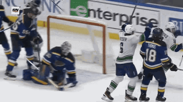 a hockey game is being played in front of a banner for enterprise