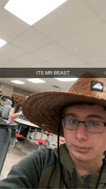 a man wearing a straw hat and glasses is taking a selfie with a caption that says its mr beast