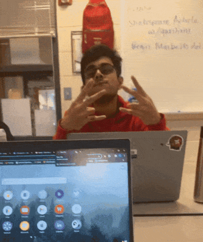 a man sitting in front of a laptop with a sticker on it that says begins march