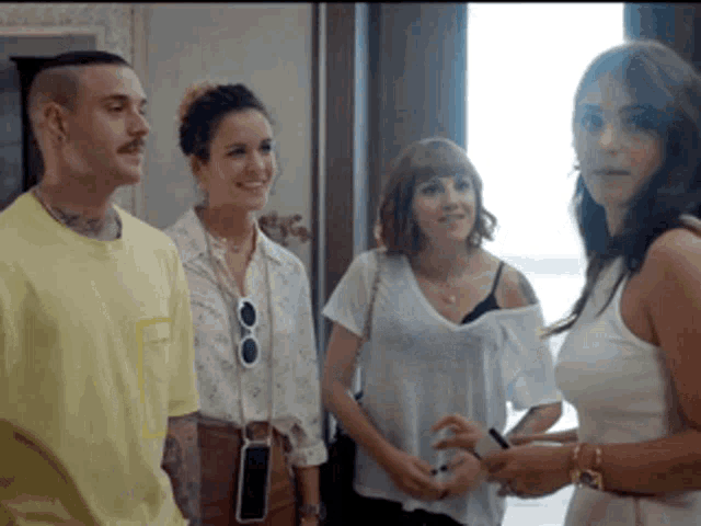 a group of people standing next to each other with one wearing a yellow shirt