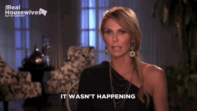 a woman says it wasn 't happening in front of a real housewives sign