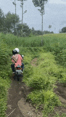 a person riding a motorcycle on a dirt road with a license plate that says ' tk - 88 '