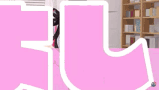 a 3d anime girl is sitting on a couch in a living room with a pink background .
