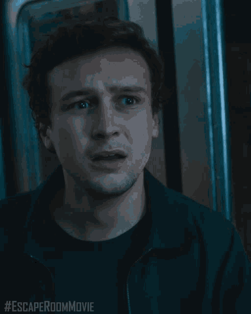 a close up of a man 's face with the words #escaperoommovie written below him