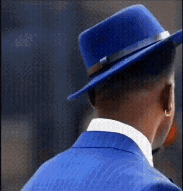 a man in a blue suit and blue hat