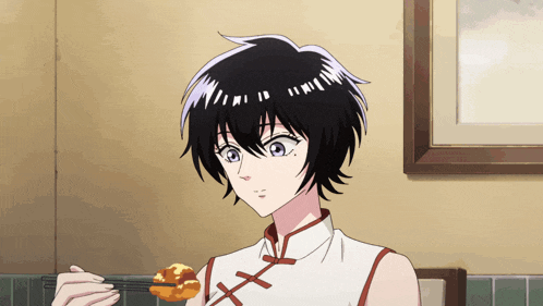 a girl with short black hair is holding a piece of food in her hand