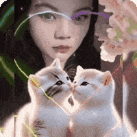 a woman and two kittens are kissing in front of flowers
