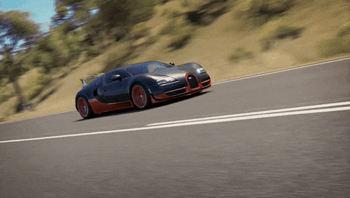 a black and red sports car is driving down the road