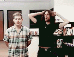 a man in a plaid shirt stands next to another man