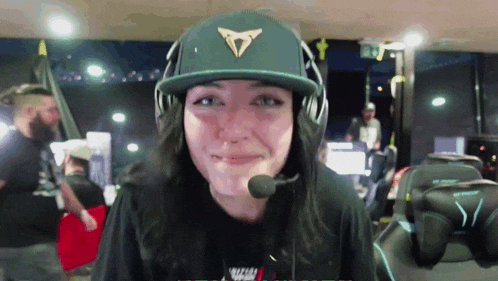 a woman wearing a hat and headphones with a microphone