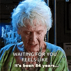 an elderly woman in a green shirt is waiting for you feels like it 's been 84 years ...