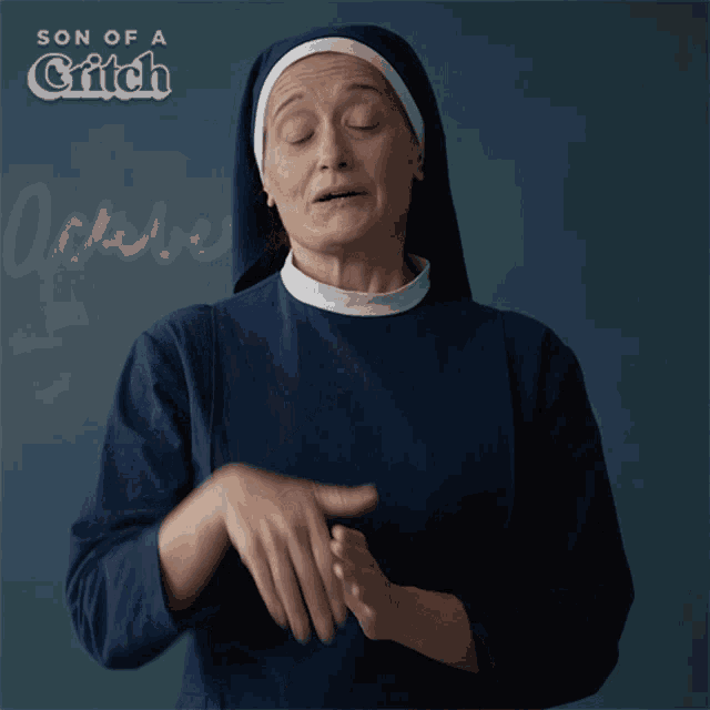 a nun in front of a blackboard with the words son of a critch written on it